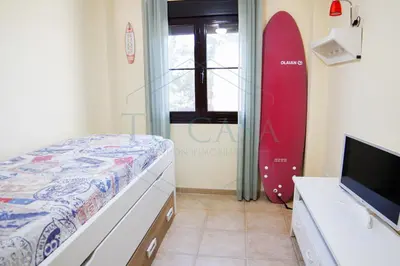 a bedroom with a bed and a snowboard in it at Ático, El Refugio de Sancti Petri in Novo Sancti Petri
