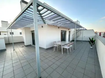 a patio with a table and chairs on a roof at GATU Atikus in El Puerto de Santa María
