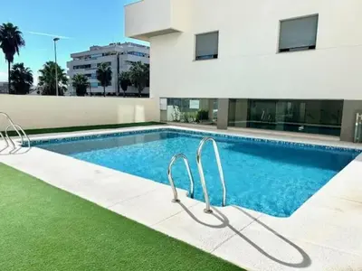 a swimming pool in front of a building at GATU Atikus in El Puerto de Santa María