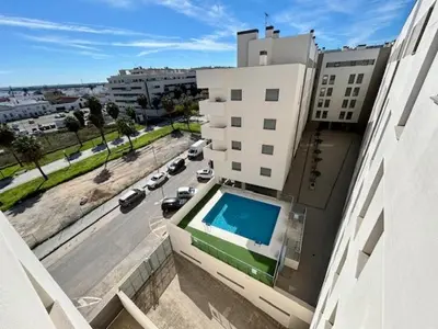 a view of a building with a swimming pool at GATU Atikus in El Puerto de Santa María