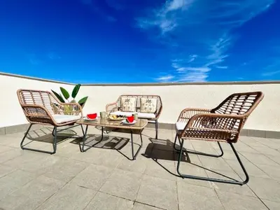 three chairs and a table on a patio at GATU Atikus in El Puerto de Santa María