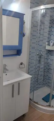 a bathroom with a shower and a sink and a mirror at Loft El pez blanco in El Puerto de Santa María
