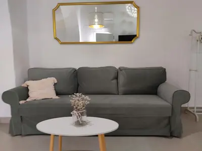 a living room with a couch and a table at La corrala de la calle Sol in Jerez de la Frontera