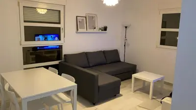 a living room with a couch and a table at Acogedor apartamento en Bahía Blanca, Cádiz a 3 min de la playa in Cádiz