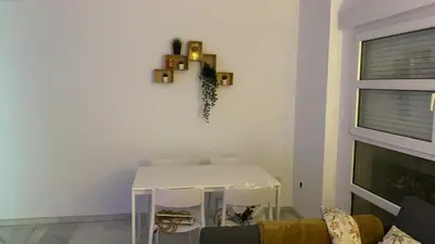 a living room with a white table and a couch at Acogedor apartamento en Bahía Blanca, Cádiz a 3 min de la playa in Cádiz