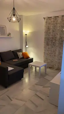 a living room with a couch and a table at Acogedor apartamento en Bahía Blanca, Cádiz a 3 min de la playa in Cádiz