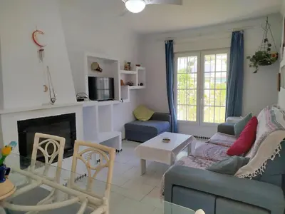 a living room with a couch and a fireplace at Villa Duplex 3 Bedrooms, 400 M to the beach, Pool in Novo Sancti Petri