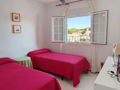 a bedroom with two beds and a window at Villa Duplex 3 Bedrooms, 400 M to the beach, Pool in Novo Sancti Petri