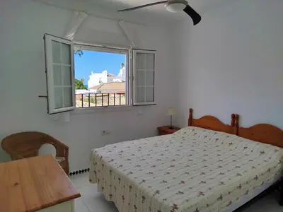 a bedroom with a bed and a window at Villa Duplex 3 Bedrooms, 400 M to the beach, Pool in Novo Sancti Petri