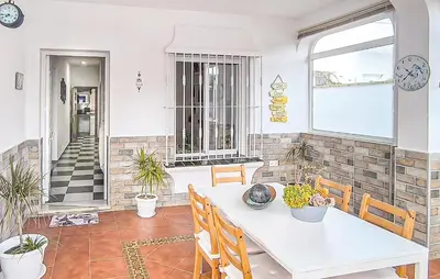 a dining room with a white table and chairs at Stunning Home In Chiclana De La Fronter in Novo Sancti Petri