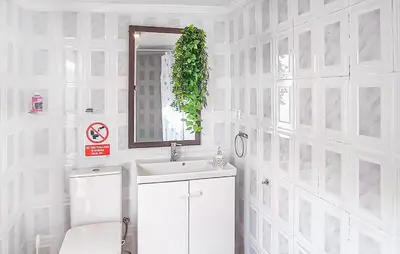 a white bathroom with a sink and a mirror at Stunning Home In Chiclana De La Fronter in Novo Sancti Petri