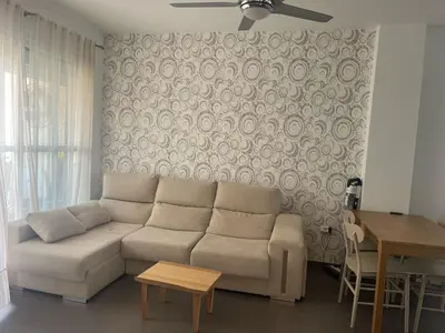 a living room with a couch and a table at Apartamento Sanlúcar in Sanlúcar de Barrameda