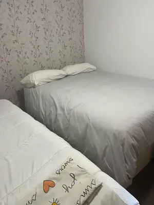 two beds sitting next to each other in a room at Apartamento Sanlúcar in Sanlúcar de Barrameda
