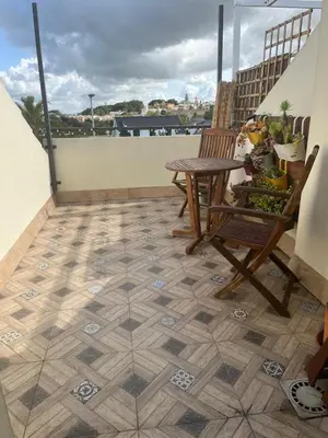 a patio with a table and chairs on a balcony at Apartamento Sanlúcar in Sanlúcar de Barrameda