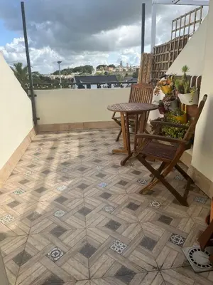 a patio with a table and chairs on a balcony at Apartamento Sanlúcar in Sanlúcar de Barrameda