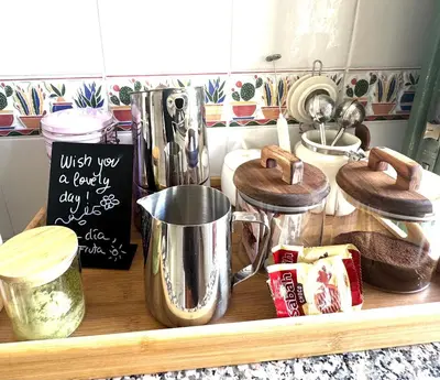 a kitchen counter with a shelf with pots and pans at a casiña cottage in Chiclana in Chiclana de la Frontera