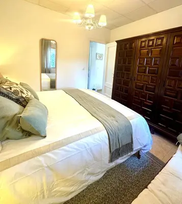 a bedroom with a large bed and a mirror at a casiña cottage in Chiclana in Chiclana de la Frontera