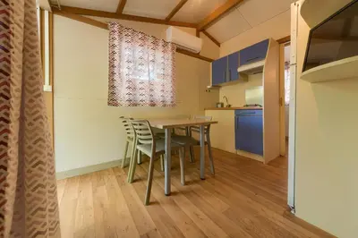a patio with a table and chairs on a deck at Bungalows - Conil Playa in Conil de la Frontera