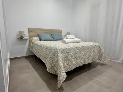 a bedroom with a bed with two pillows on it at Casa Abuelo Pedro in Conil de la Frontera
