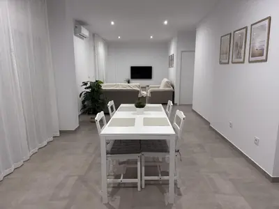 a white table and chairs in a living room at Casa Abuelo Pedro in Conil de la Frontera