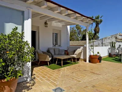 a patio with chairs and a white building at Apartamento El Convento - Ole Solutions in Jerez de la Frontera