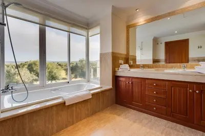 a bathroom with a tub and a large window at Villa 237 by Villamya in Arcos de la Frontera