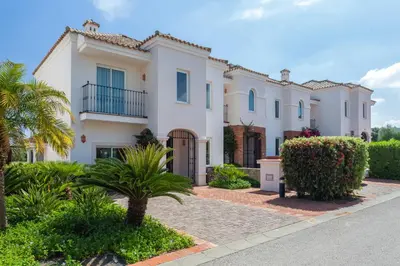 a large white house with palm trees and bushes at Villa 237 by Villamya in Arcos de la Frontera