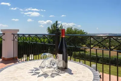 a bottle of wine sitting on top of a table at Villa 235 by Villamya in Arcos de la Frontera