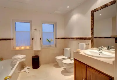 a bathroom with a sink toilet and a mirror at Villa 235 by Villamya in Arcos de la Frontera