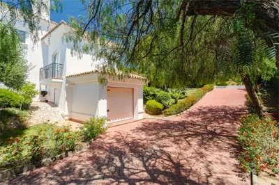 a driveway leading to a white house with a garage at Villa 235 by Villamya in Arcos de la Frontera