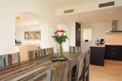 a dining room table with a vase of flowers on it at Villa 236 by Villamya in Arcos de la Frontera