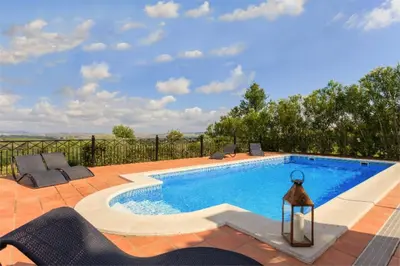 a swimming pool with chairs and a lamp next to it at Villa 236 by Villamya in Arcos de la Frontera