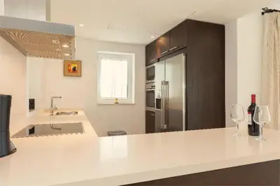 a kitchen with a large white counter with wine glasses at Villa 236 by Villamya in Arcos de la Frontera