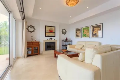 a living room with a white couch and a fireplace at Villa 236 by Villamya in Arcos de la Frontera