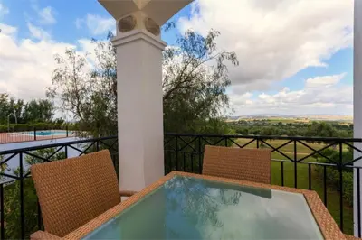 a balcony with two chairs and a swimming pool at Villa 236 by Villamya in Arcos de la Frontera