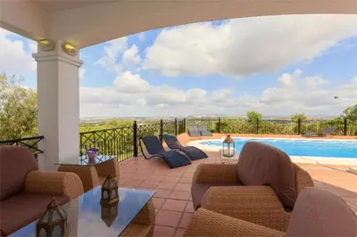 a patio with chairs and a swimming pool with a view at Villa 236 by Villamya in Arcos de la Frontera