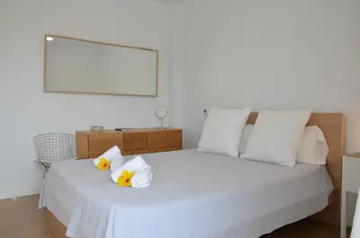 a bedroom with a white bed with towels on it at Villa Puntalejo por Living Cadiz in Conil de la Frontera