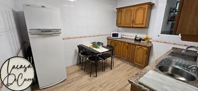 a kitchen with a refrigerator and a small table at La casa de curro in Arcos de la Frontera