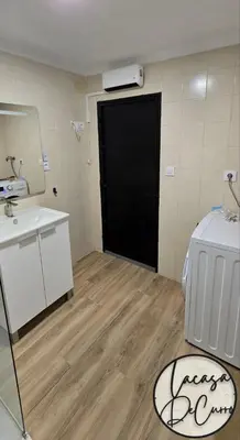 a bathroom with a black door and a sink at La casa de curro in Arcos de la Frontera