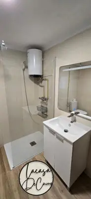 a bathroom with a white sink and a shower at La casa de curro in Arcos de la Frontera