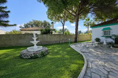a fountain in the yard of a house at Chalet Amanecer Chiclana in Novo Sancti Petri