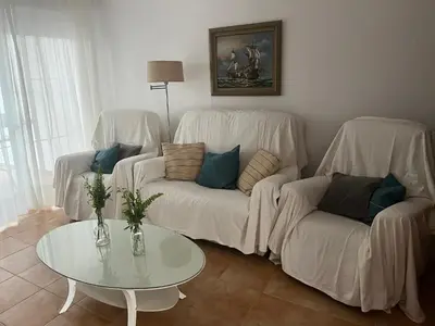 a living room with two white couches and a table at La Balconera Apartamento junto a la playa in Novo Sancti Petri