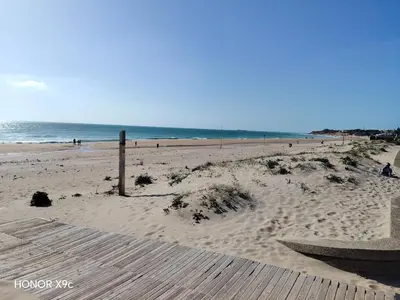 people riding horses on the beach at sunset at Beachside Duplex Chalet -800 m to La Barrosa Beach in Novo Sancti Petri