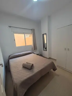 a bedroom with a bed with a towel on it at Apartamento Bahia de Cadiz in Puerto Real