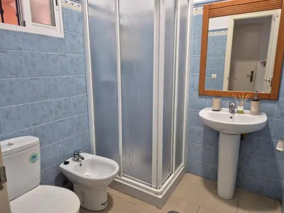 a bathroom with a toilet and a sink and a shower at Apartamento Bahia de Cadiz in Puerto Real