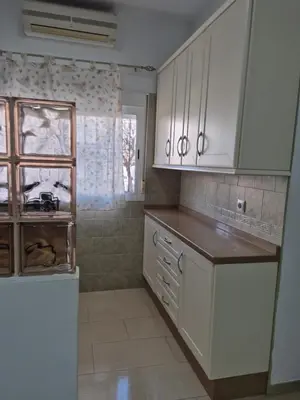a white bedroom with a bed and white cabinets at Apartamento Bahia de Cadiz in Puerto Real