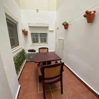 a small table and chairs on a balcony with a window at Bulerías de Cádiz by Gades Gestión in Cádiz
