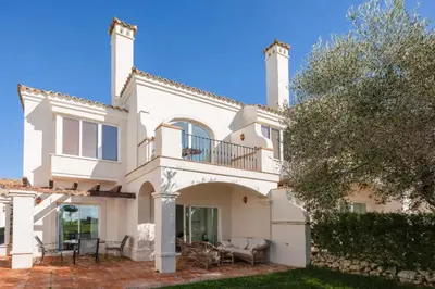 a white house with a balcony and a tree at Villa 231 by Villamya in Arcos de la Frontera