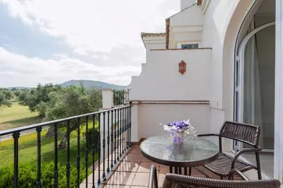 a patio with a table and chairs on a balcony at Villa 231 by Villamya in Arcos de la Frontera