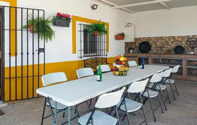 a long table and chairs in a room at Awesome Home In San José Del Valle in San Jose del Valle